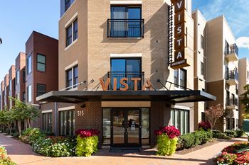 The Vista Apartments building is surrounded by a well-manicured garden.